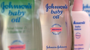 Johnson & Johnson baby oil is arranged on the shelf for an illustration at Skenderian Apothecary in Cambridge, Massachusetts on Tuesday, Jan. 23, 2007. Johnson & Johnson, the world's biggest health-care products company, said profit rose 3.5 percent, led by sales of the Risperdal schizophrenia drug. The shares fell as revenue overall missed analyst expectations. Photographer: JB Reed/Bloomberg News.