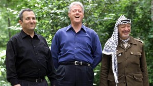 CAMP DAVID, UNITED STATES:  Israeli Prime Minister Ehud Barak (L), US President Bill Clinton (C), and Palestinian leader Yasser Arafat (R) pose for a photograph at Laurel Cabin the site where former Egyptian President Anwar Sadat, former Israeli Prime Minister Menachem Begin, and former US President Jimmy Carter conducted peace talks in 1978, during the Middle East Peace Summit 11 July 2000 at Camp David, Maryland, the US presidential mountain top retreat. The peace talks are aimed at resolving the issues of the 52-year-old Israeli-Palestinian conflict including the status of Jerusalem, the borders and nature of a Palestinian state, and the future of Jewish settlers and Palestinian refugees.  (ELECTRONIC IMAGE)   AFP PHOTO/Stephen JAFFE (Photo credit should read STEPHEN JAFFE/AFP/Getty Images)